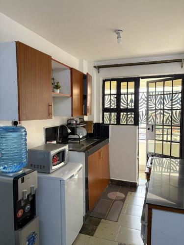 Cozy 1BR with Kitchen Balcony and Wi Fi near CBD