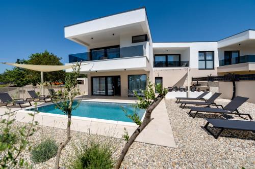 Villa Mirakul new modern villa with swimming pool close to the beach children playroom quiet area by TRAVELER tourist agency Krk ID 2680 — 4-Star Luxury Hotel in Omisalj, Croatia