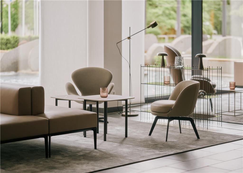 Seating area with armchairs, sofas and side tables in the entrance lobby