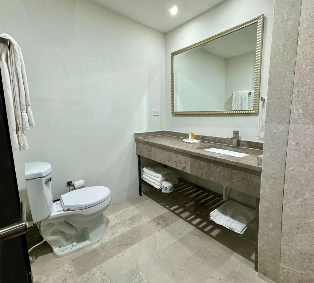 Our room's bathroom features a spacious shower, sleek vanity, and soft towels. It's a modern and comfortable space to refresh.
