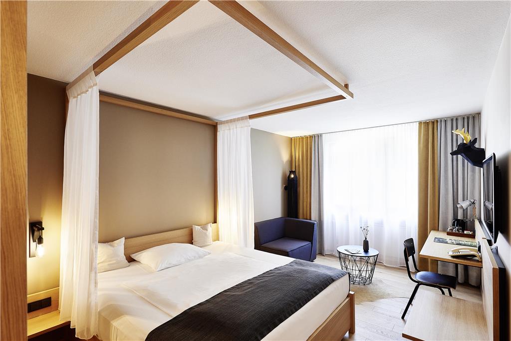 Medieval-accented rooms with oak parquet flooring and four-poster bed.