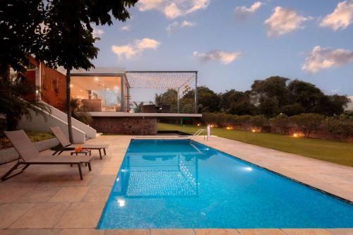 Open House by StayVista Nestled in nature featuring a Swimming pool & Expansive lawn for a serene retreat