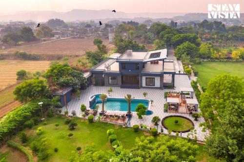 StayVista’s Hampton Acres Outdoor Pool Vast Lawn & Terrace in Faridabad, India