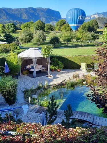 Garden Paradise Bled Apartments garden pond and castle view — 4-Star Luxury Hotel in Bled, Slovenia