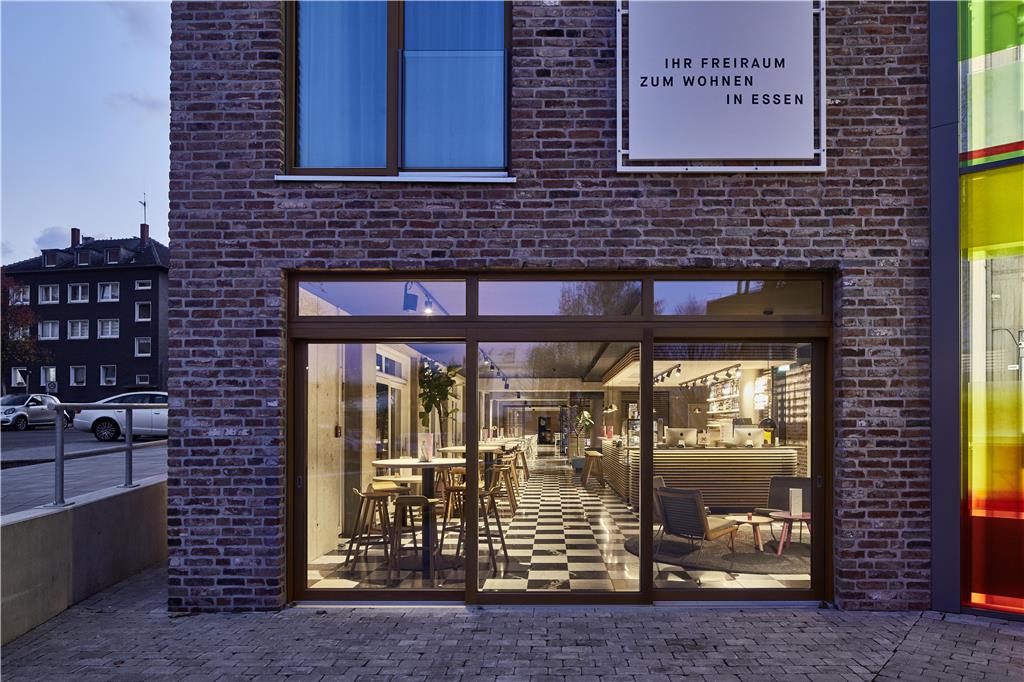 Exterior facade, view through a window front onto the hotel lobby