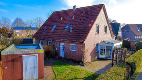 Ostfrieslandtraum mit Kamin und Wintergarten - carbon neutral hotel in Dornum