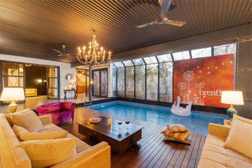 StayVista’s The Barn House Farm View Villa with with bonfire Indoor Pool & Bar