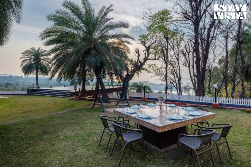 StayVista’s Lake Pearl Serenity Riverside Mountain View Villa with Jacuzzi Sprawling Lawn & Terrace