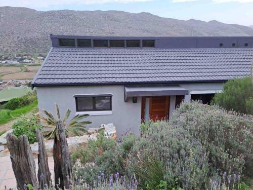 Modern mountainside home with ocean view Minimal load shedding
