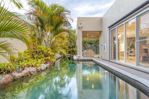 Luxury resort style villa pool by Custom Bnb Hosting — 4-Star Luxury Hotel in Pelican Waters, Australia