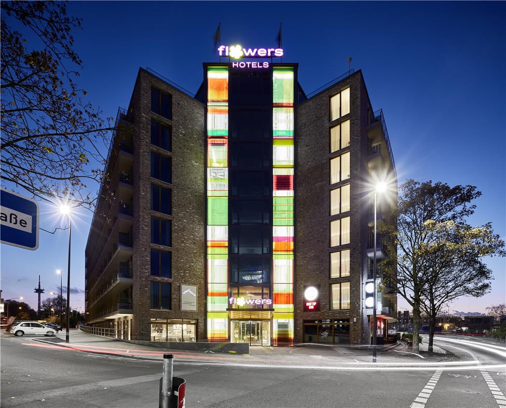Exterior facade of the hotel, photographed frontally in the dark