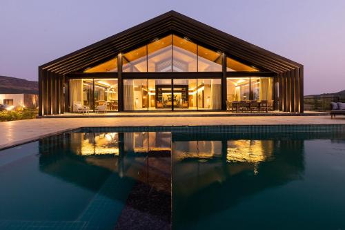 StayVista’s The Barn Mountain View Luxury Mansion with Heated Infinity Pool Deck Jacuzzi Lawn featuring a Gazebo and Firepit in Lonavla, India